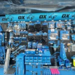 A retail display wall featuring a wide variety of OX brand hand tools and construction equipment