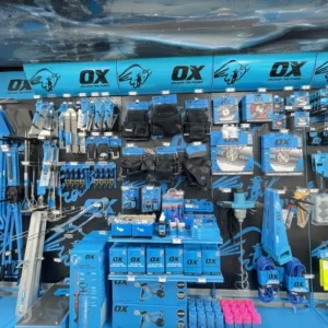 A retail display wall featuring a wide variety of OX brand hand tools and construction equipment
